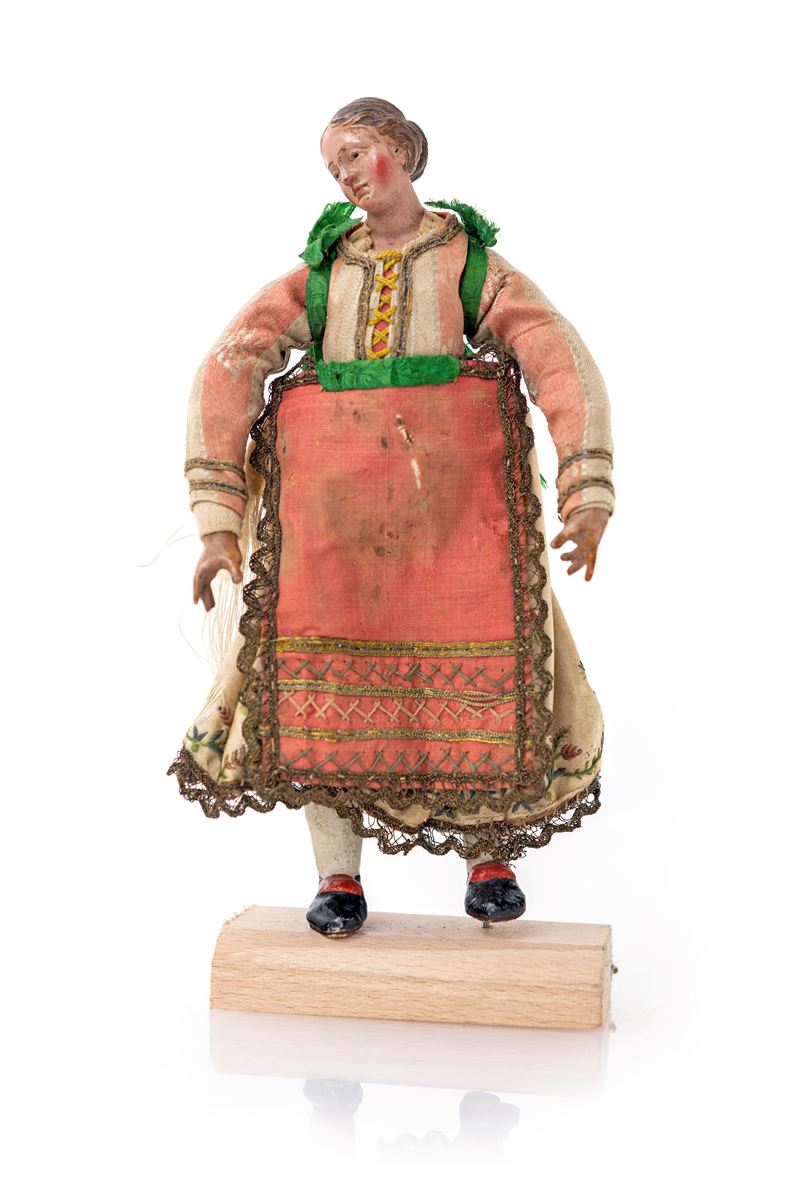 Giovane procidana con chignon e vestitura impreziosita da ricami e galloni