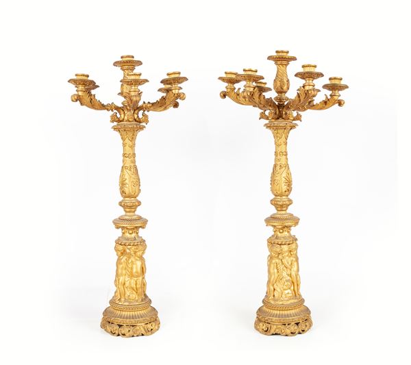 Coppia di candelabri in metallo dorato a sette luci, XIX secolo