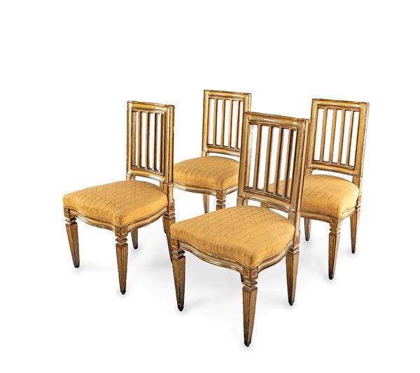 Quattro sedie in legno laccato avorio con profili dorati, fine del XVIII secolo
