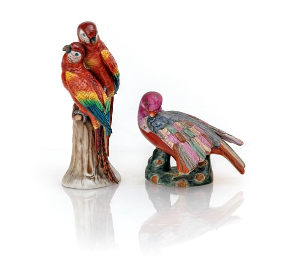 Due gruppi in porcellana policroma con pappagalli ara, manifatture diverse