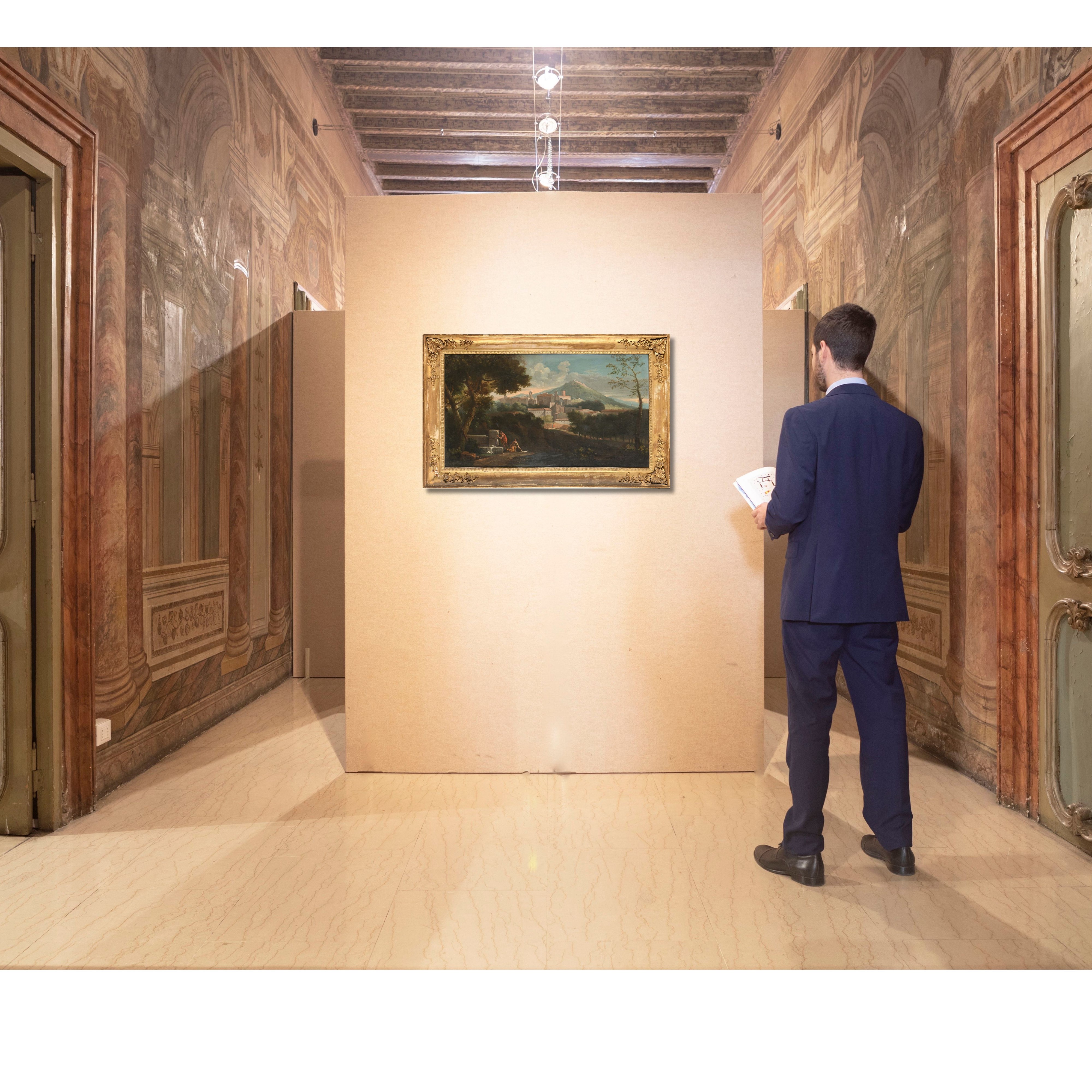 Paesaggio fluviale con figure al fontanile e borgo in lontananza