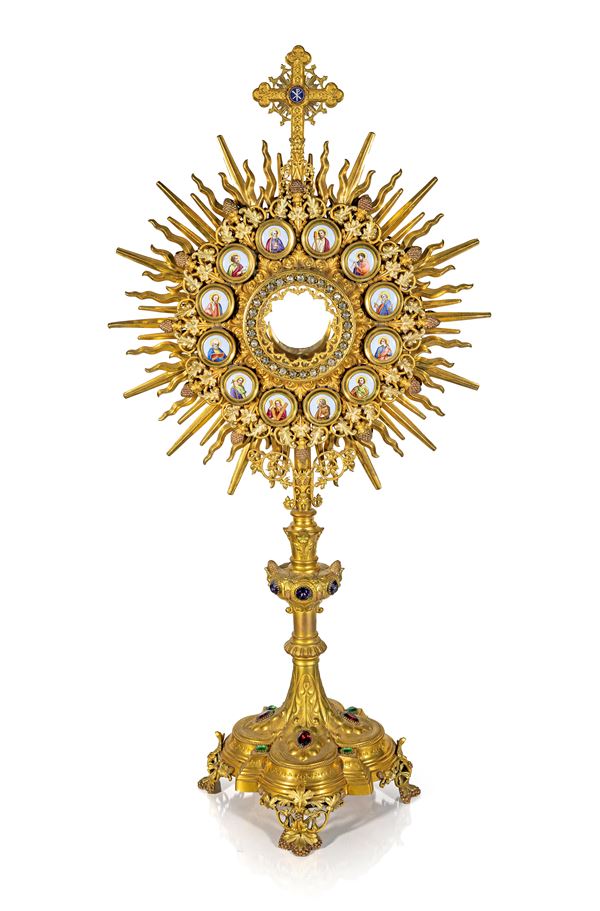 Grande ostensorio a raggiera in metallo e bronzo dorati con placche in smalti policromi e gemme colorate, XX secolo