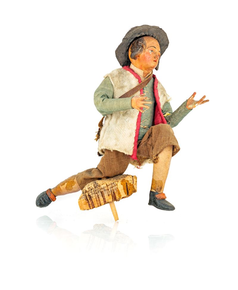 Giovane pastore della meraviglia con cappello e bisaccia, inginocchiato