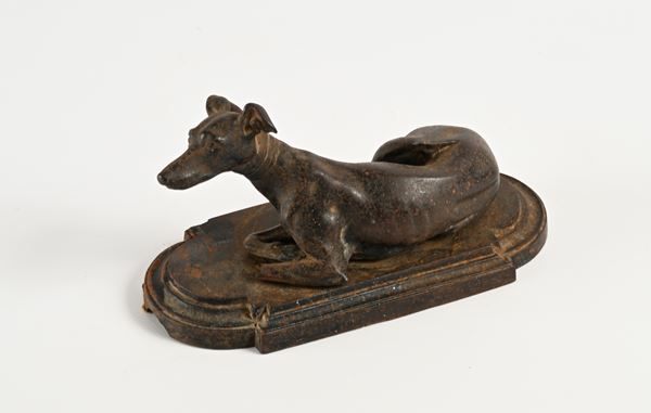 Scultura in metallo raffigurante levriero accucciato