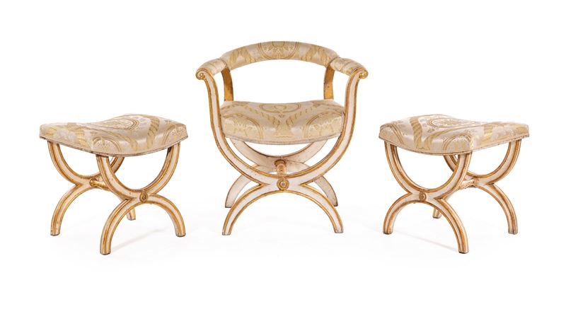 Poltrona a faldistorio e coppia di sgabelli neoclassici, legno laccato bianco con profili dorati,...