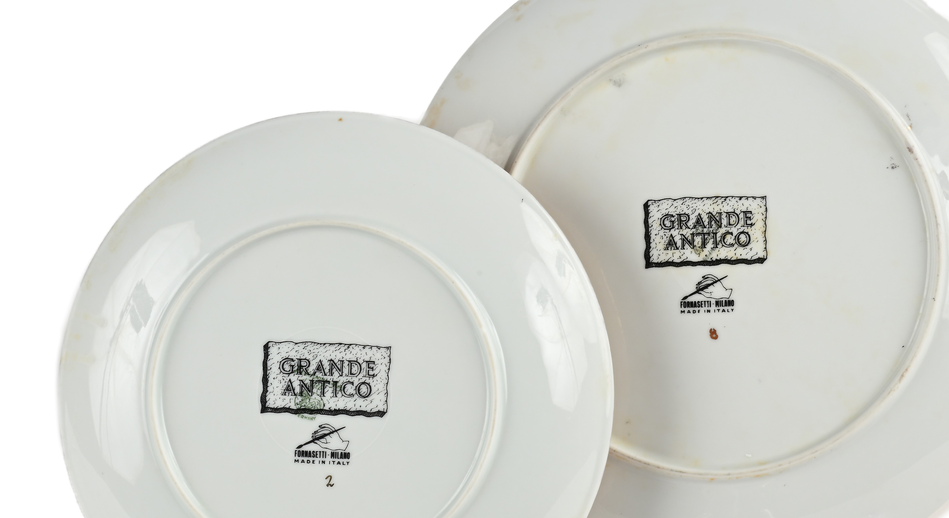 Servizio di piatti Fornasetti in porcellana dorata