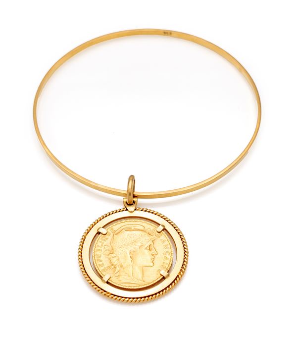 Bracciale rigido in oro con pendente 20 franchi francesi.