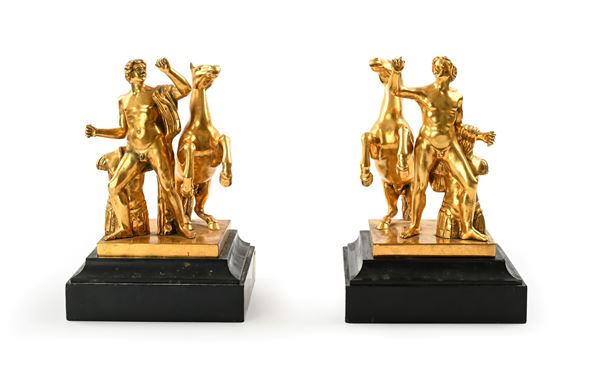 Coppia di sculture in bronzo dorato raffiguranti dioscuri, XX secolo