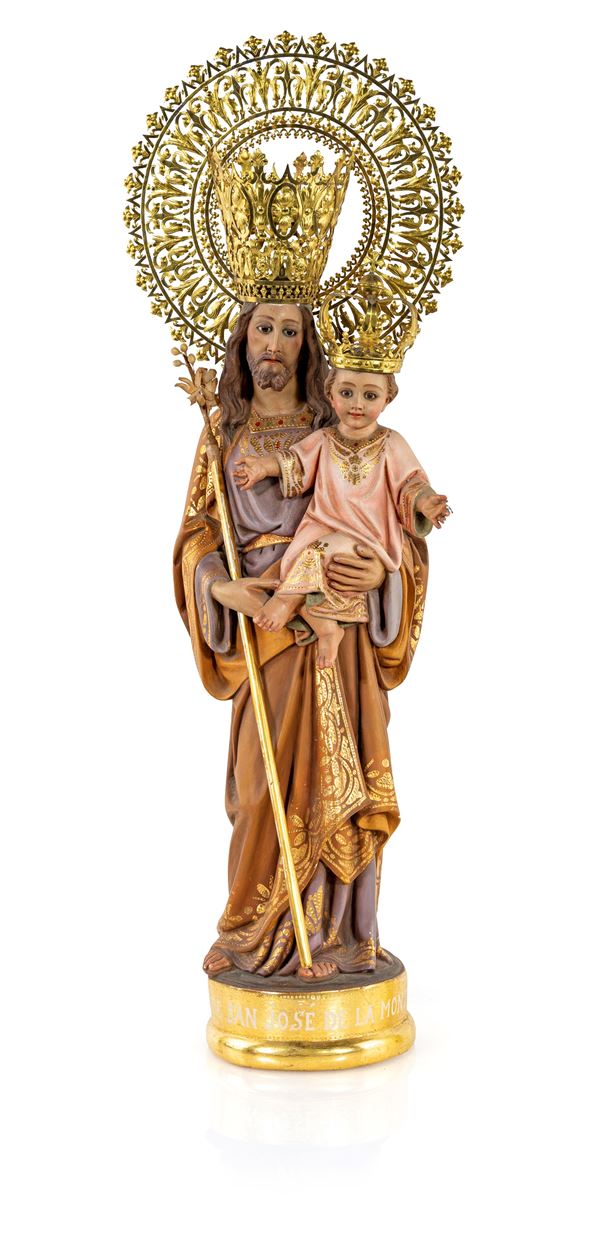 San Giuseppe col Bambino in cartapesta policroma e dorata con corone e aureola in metallo dorato