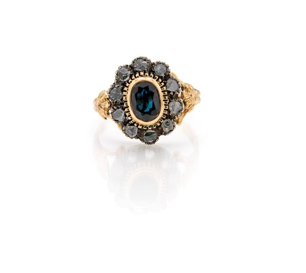 Anello in oro, argento, diamanti e zaffiro