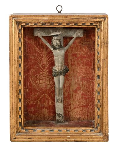 Crocifisso in pietra scolpita raffigurante Cristo arcaico, entro teca tardo ottocentesca